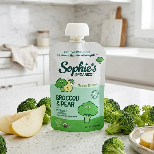 Baby snack pack featuring six green Dream snacks by Sophie's Organics, shown in a natural, lifestyle setting.