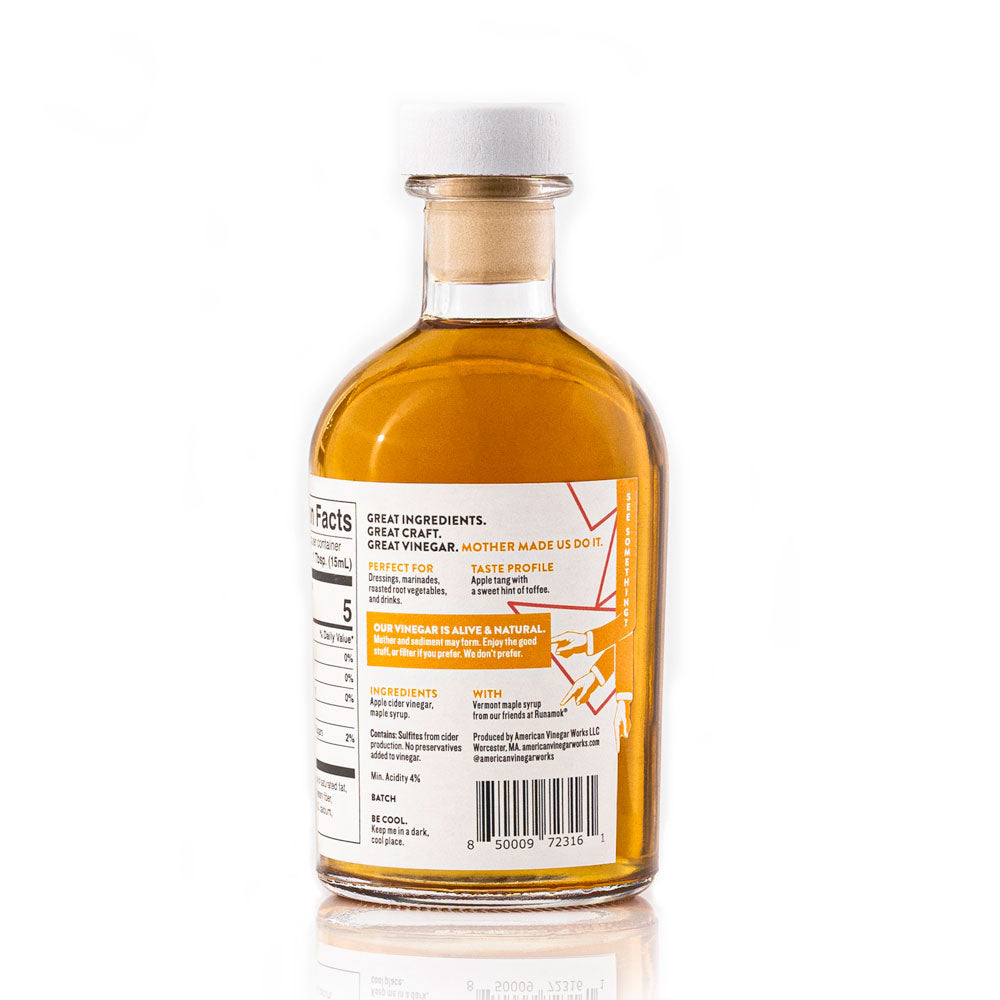 Back view of American Vinegar Works Maple Cider Vinegar bottle showing the label and clear glass container.
