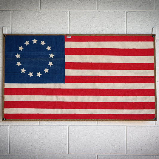 American flag crafted from fire hose by Recycled Firefighter, featuring Betsy Ross design on a white background.