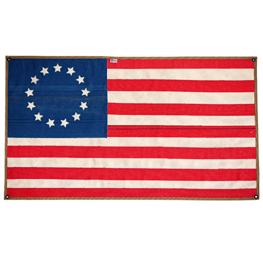 American flag made from recycled fire hose featuring Betsy Ross design, displayed on a white background.