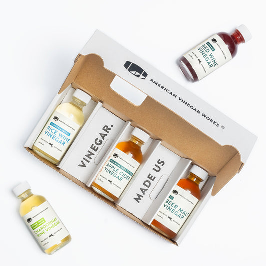 American Vinegar Works Essentials Plus vinegar sampler pack with small bottles of assorted vinegars in a set.