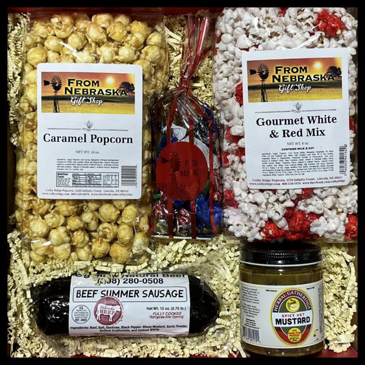 Armchair Snacks and Popcorn Gift Box from BuyNebraska.com, featuring assorted snacks in a cozy gift basket with popcorn.