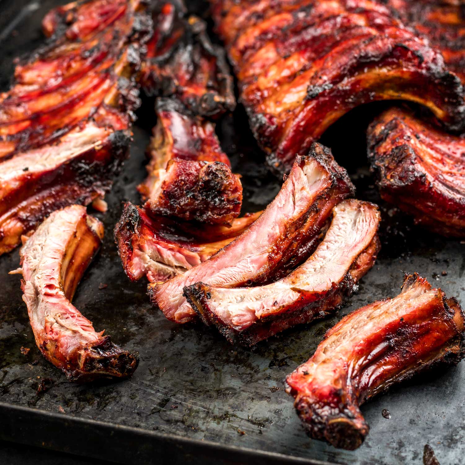 Award-winning baby back ribs from Pig of the Month BBQ, showcasing a delicious, glazed BBQ ribs sampler pack.