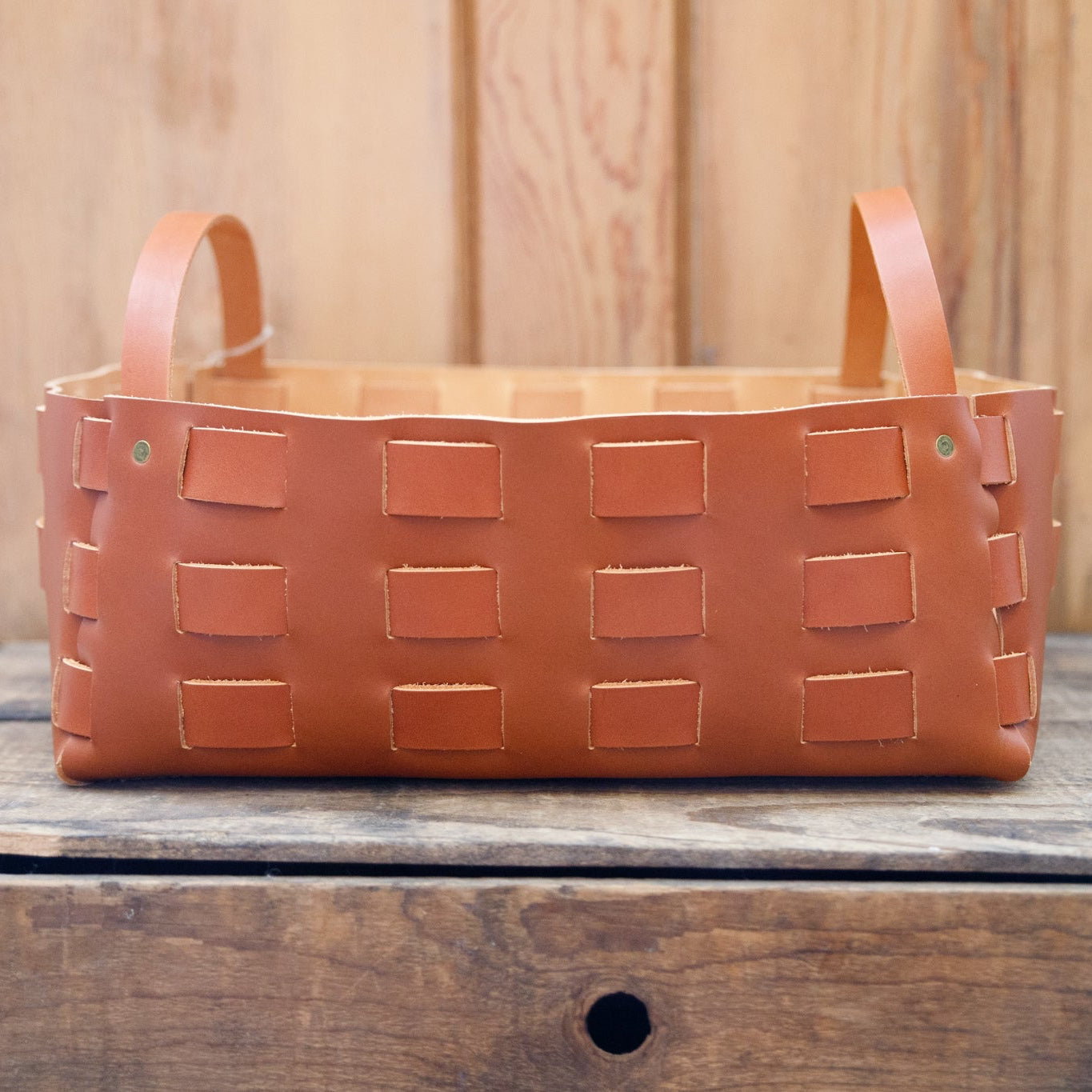 Large caramel leather woven basket by The Local Branch, showcasing a sturdy, stylish leather basket with intricate weaving details.