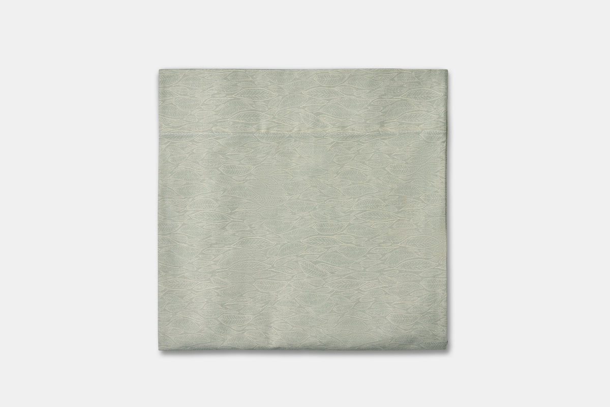 Cotton bed sheet set with green leaf print from American Blossom Linens, folded flat showing the vibrant design and soft fabric.