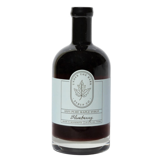 25oz bottle of Blueberry Maple Syrup by Under The Bark Syrup Co, featuring a rich blueberry and maple flavor in a clear glass bottle.