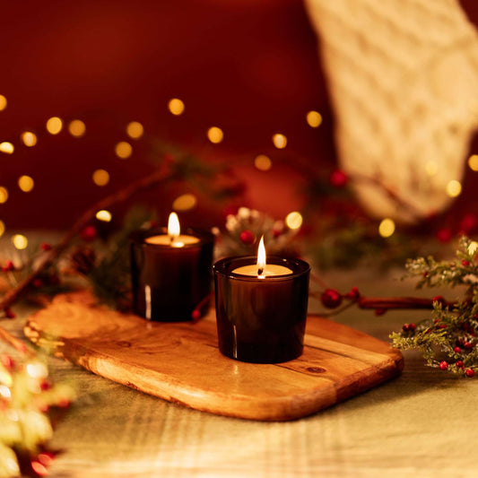 Bluecorn Beeswax Votive Candles with holiday and Christmas-themed decorations, showcasing warm, natural candlelight.