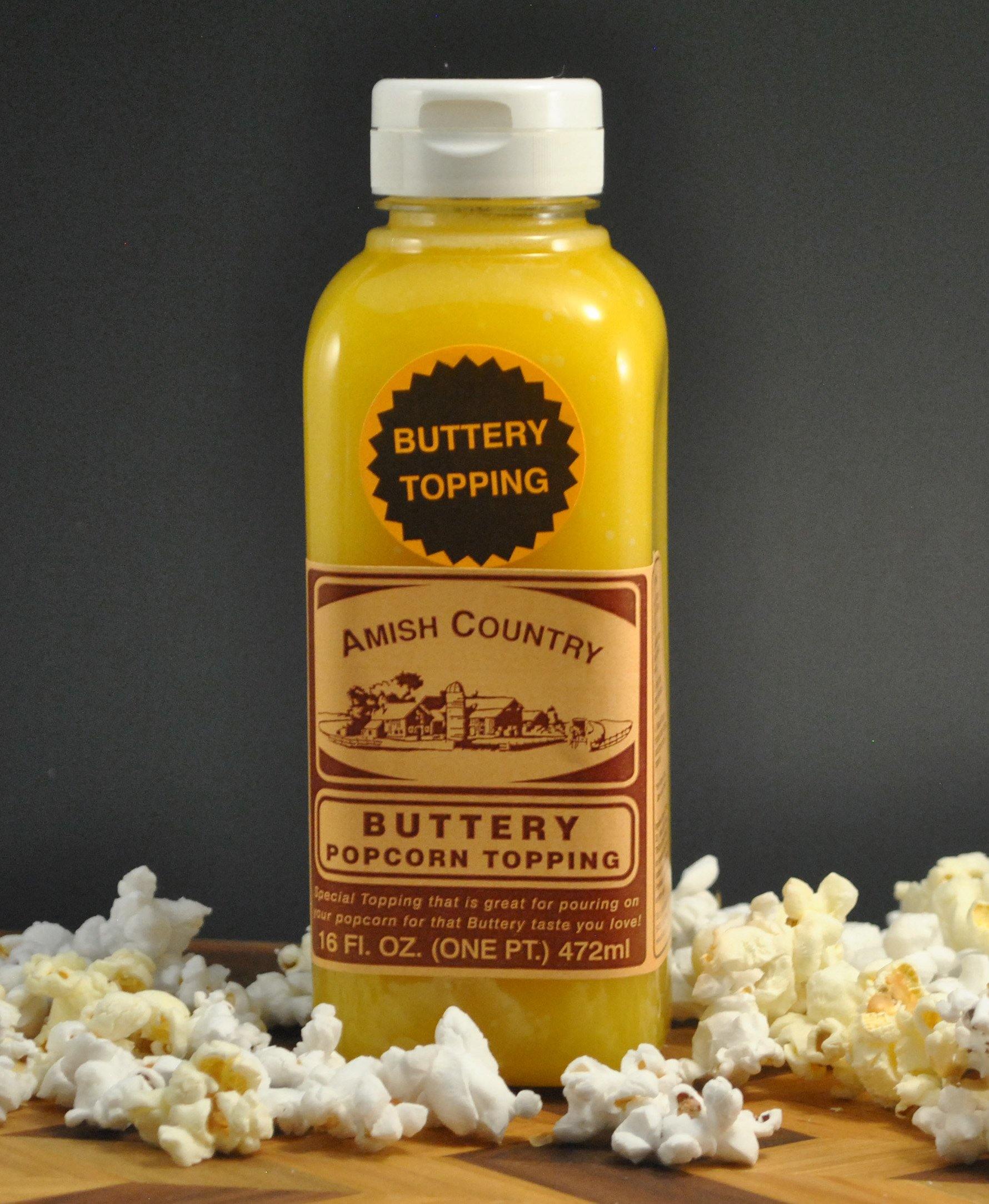 Amish Country Store buttery popcorn topping drizzled on freshly popped Amish popcorn in a bowl.