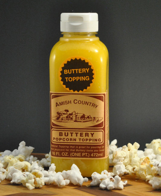 Amish Country Store buttery popcorn topping drizzled on freshly popped Amish popcorn in a bowl.