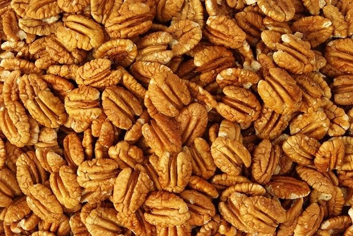 Raw Millican Pecan halves from Orchard Fresh, shelled and ready for baking or snacking in a natural, fresh appearance.
