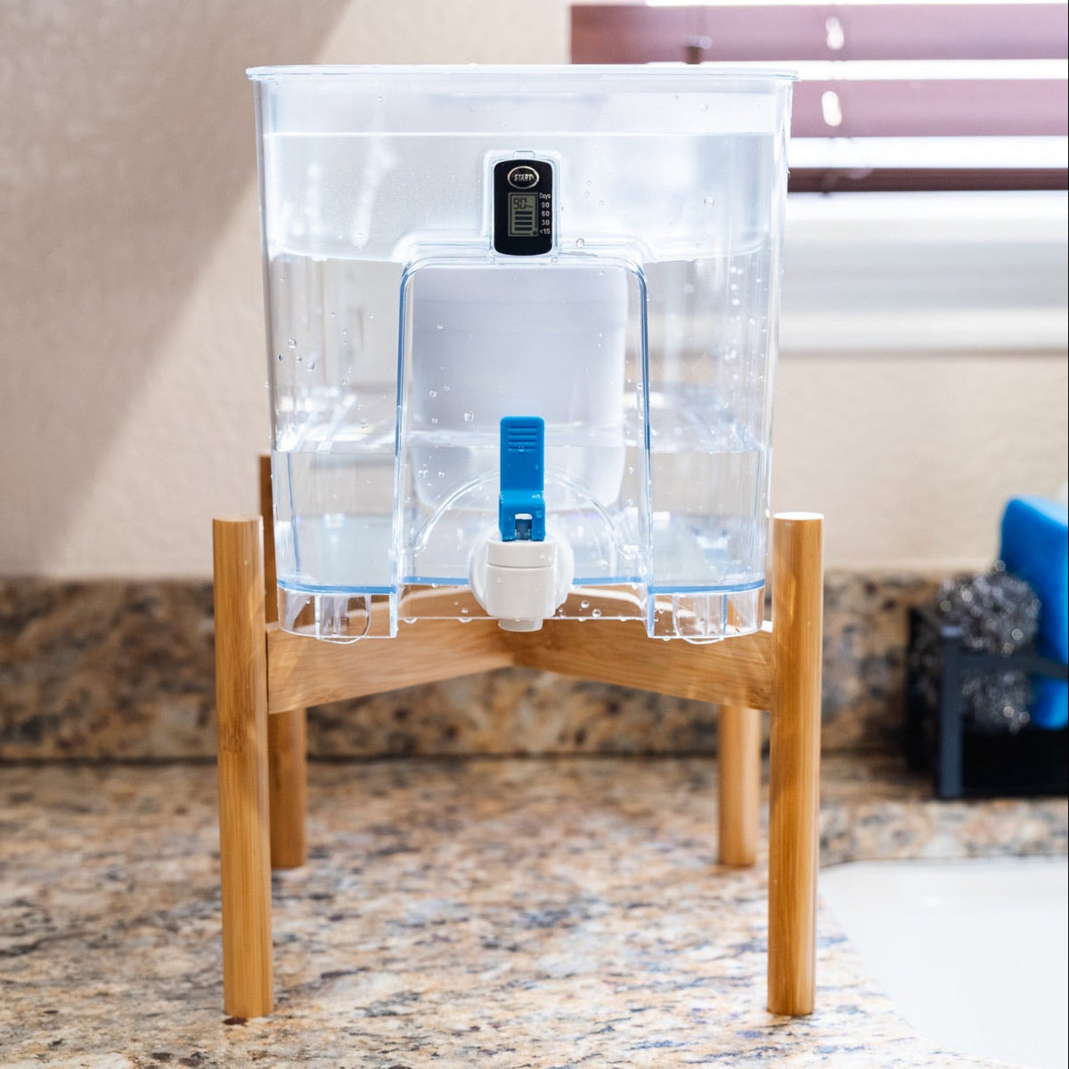 Red Epic Water Filters USA Pure XP Dispenser for reducing fluoride and PFAS, shown with transparent design and dispensing spout.