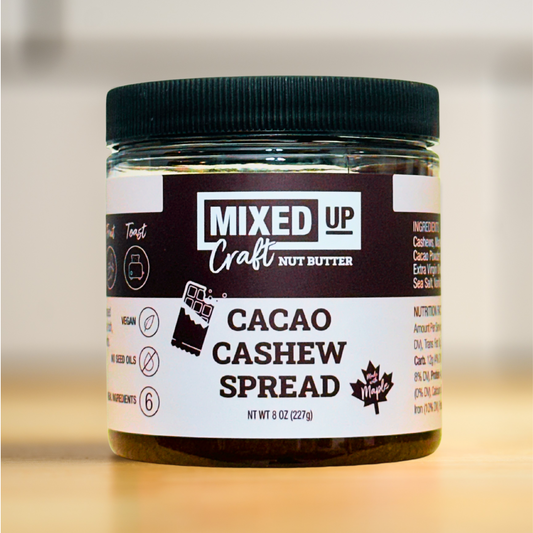 Creamy cacao cashew spread in an 8 oz jar from Mixed Up Foods, showcasing smooth nut butter with rich chocolate and nut flavors.
