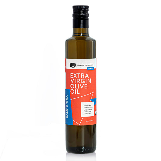 Bottle of California organic extra virgin olive oil from American Vinegar Works, with a green label and olive branch illustration.