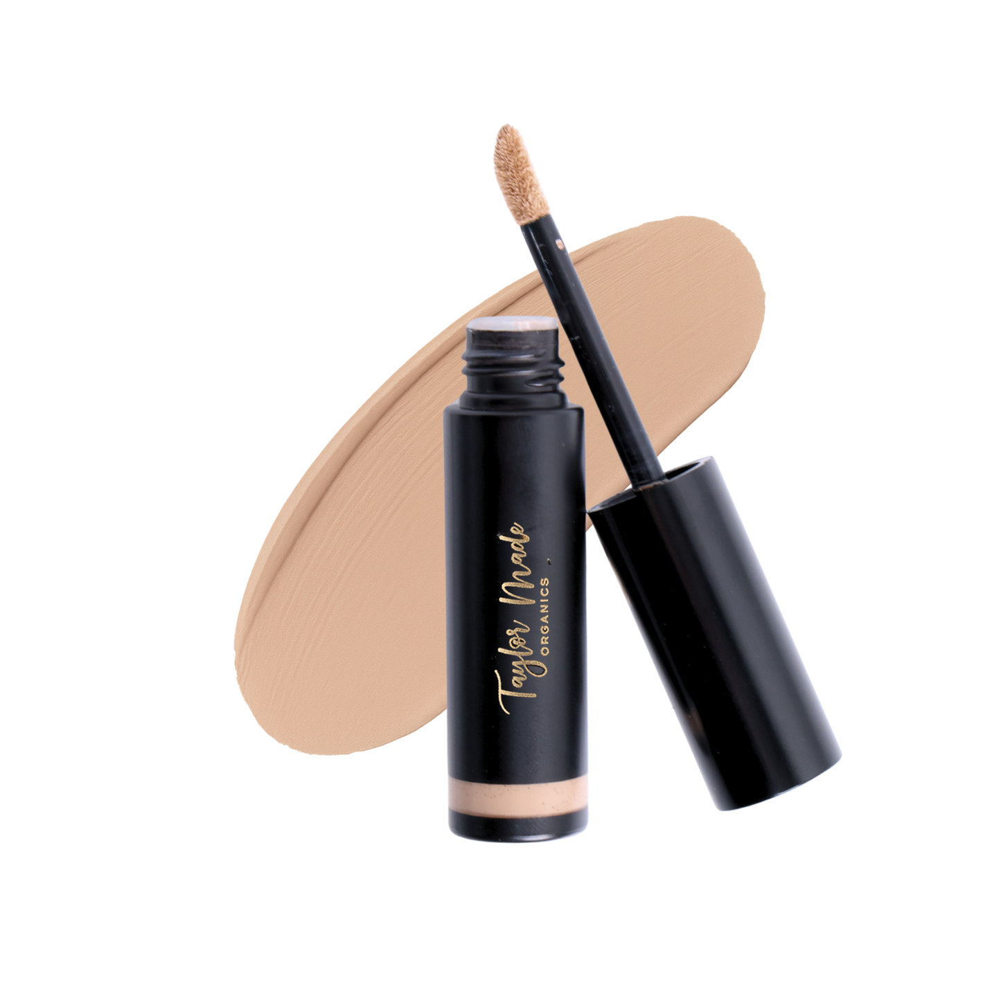 Taylor Made Organics Liquid Organic Concealer in chai shade, shown smeared on skin for natural coverage and multitasking use.