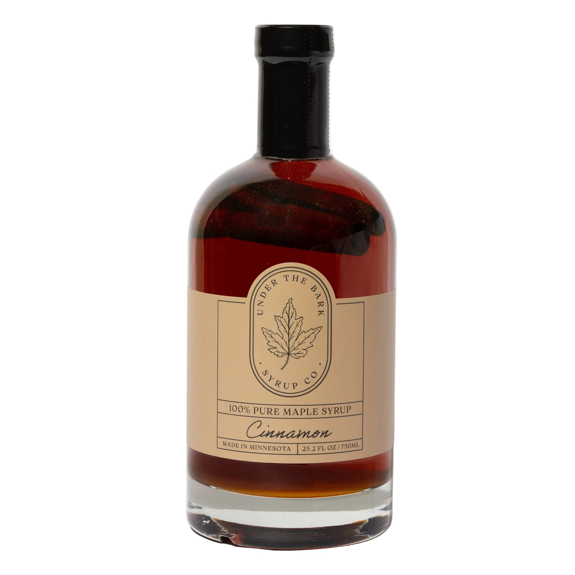 25 oz bottle of cinnamon maple syrup from Under The Bark Syrup Co, featuring rich cinnamon and maple flavors in a glass bottle.