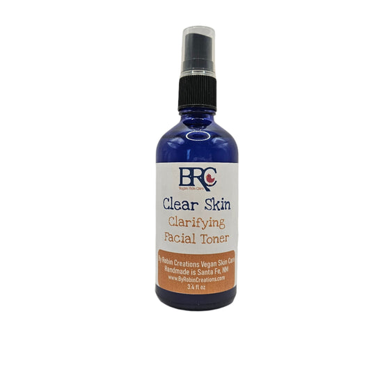 By Robin Creations Clear Skin Acne Clarifying Facial Toner spray in a clear bottle with a spray nozzle.