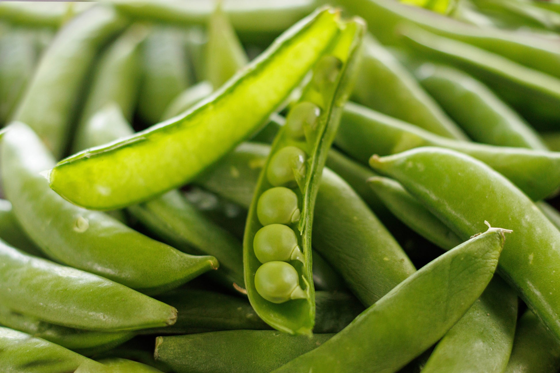 Close-up of peas from the Heirloom Max Seed Kit by Heaven's Harvest, showcasing fresh green peas in a natural setting.