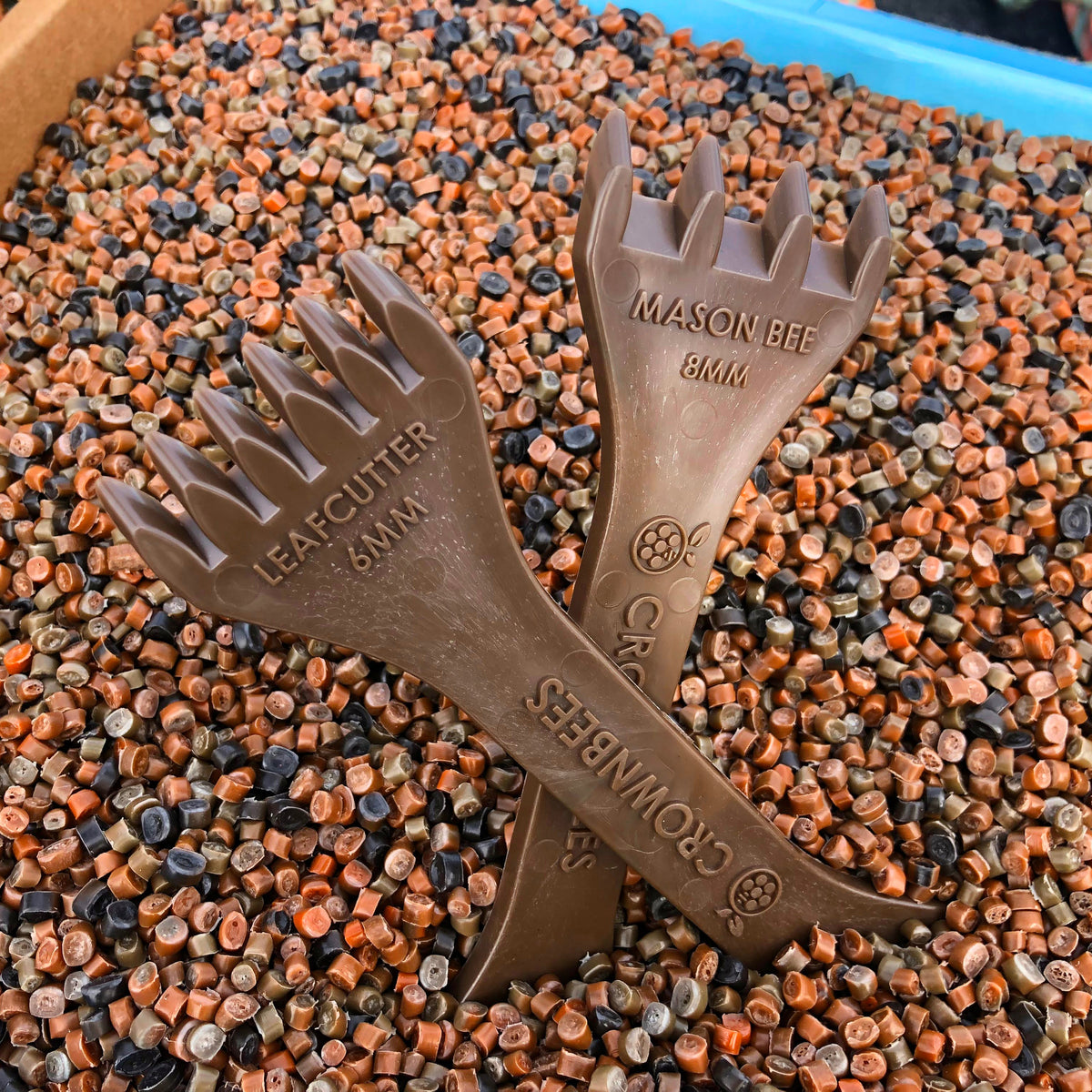 CrownBees Cocoon Harvesting Comb with wooden handle and plastic teeth for harvesting bee cocoons in beekeeping.