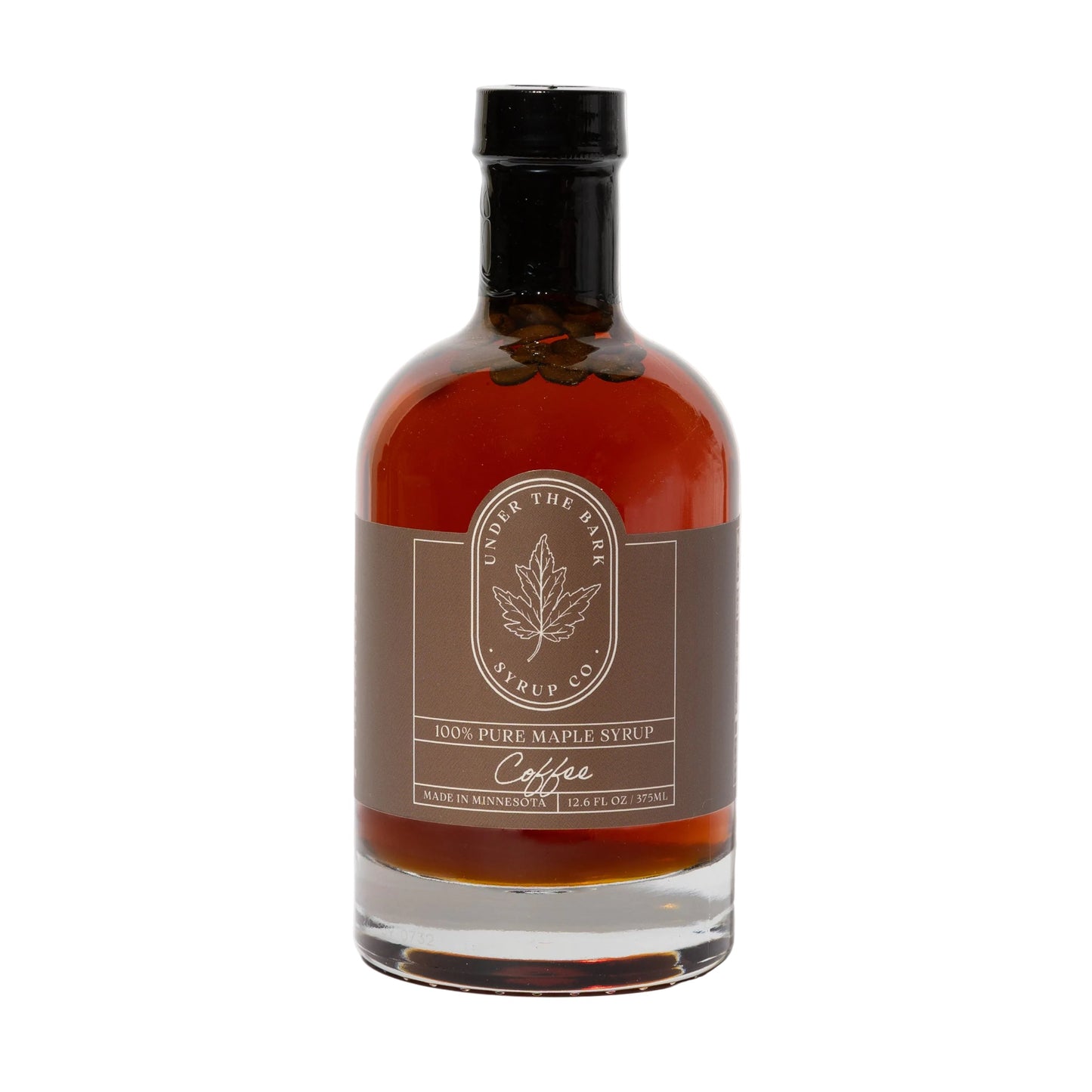 12oz bottle of Under The Bark Syrup Co Coffee Maple Syrup, rich and sweet with coffee and maple flavors, in a clear glass bottle.