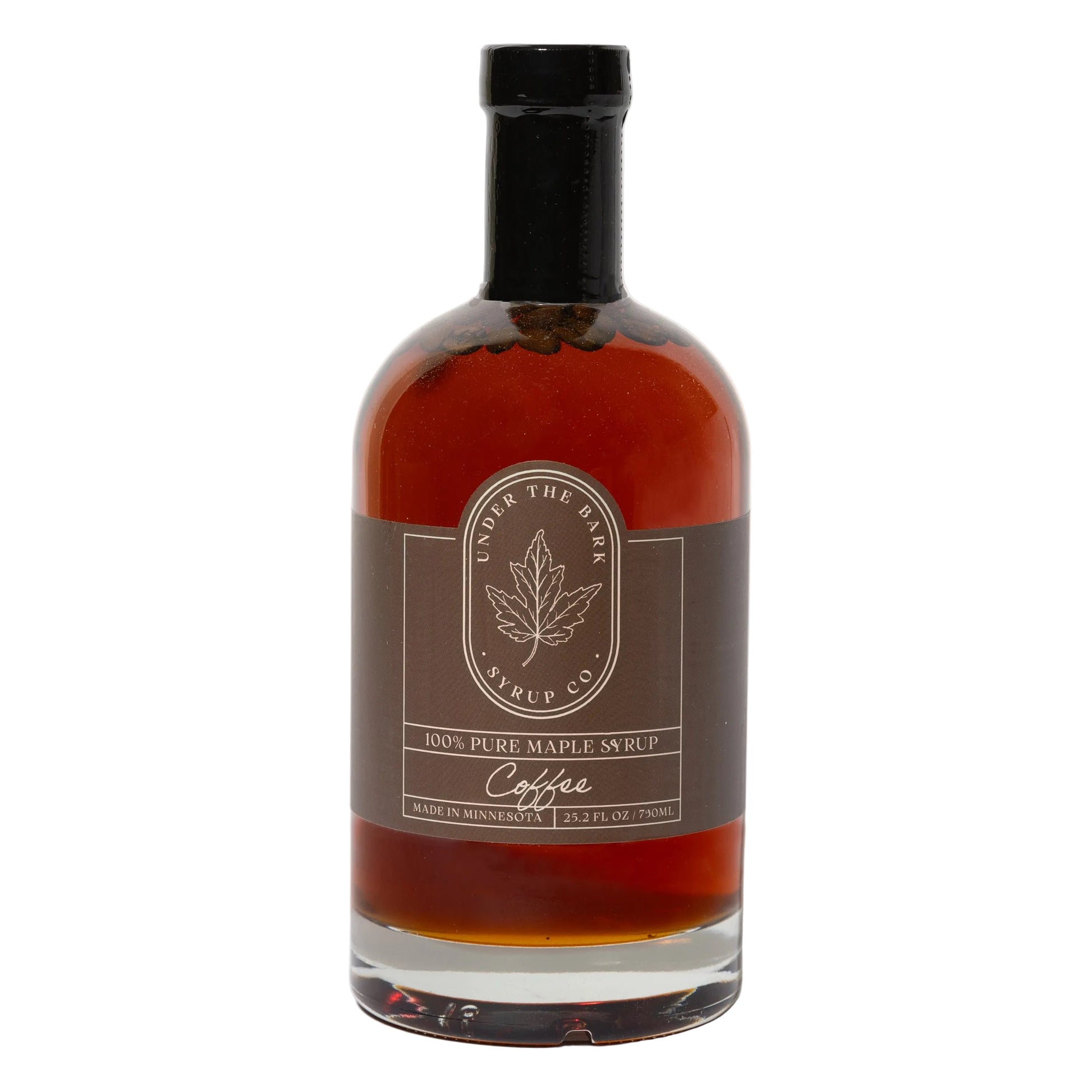 25oz bottle of Coffee Maple Syrup by Under The Bark Syrup Co, pouring rich, dark syrup into a cup for flavored coffee.