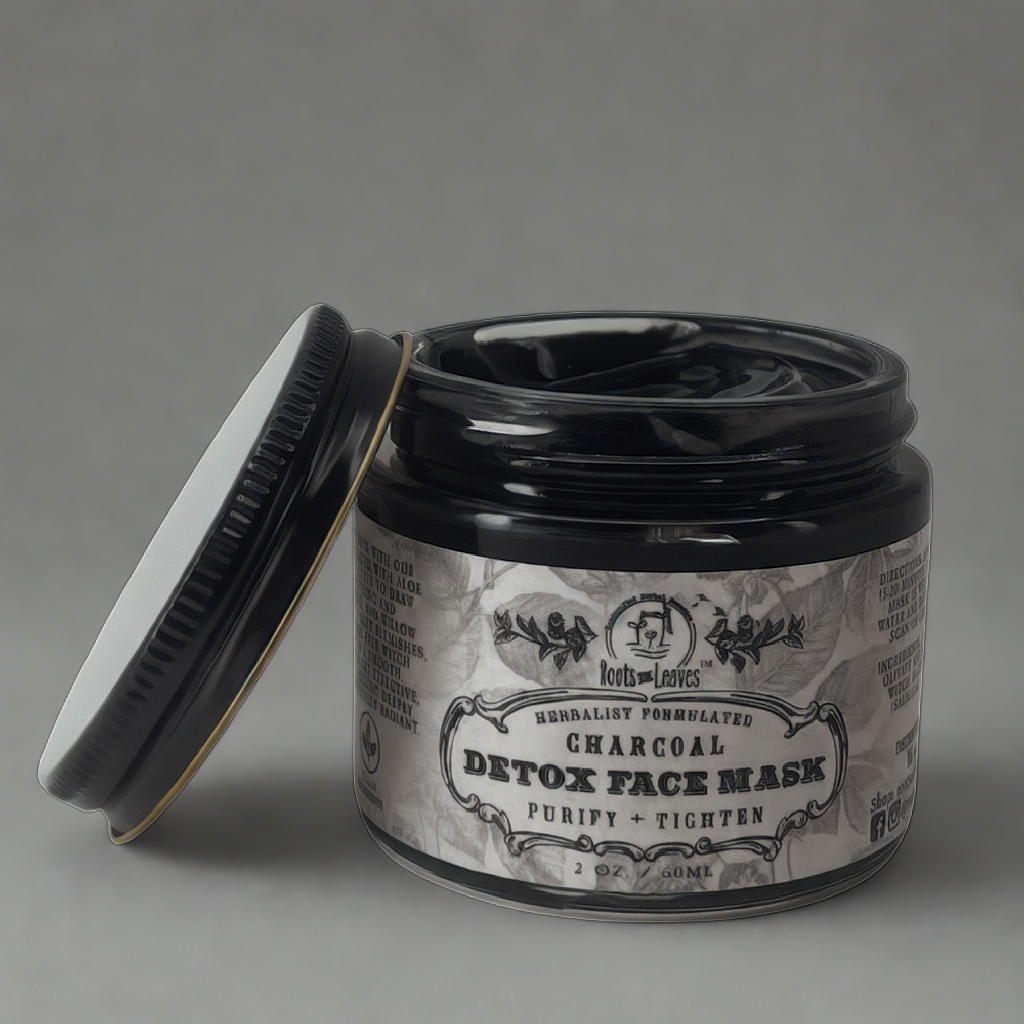 Charcoal detox face mask in a jar, with black clay texture, from Roots and Leaves LLC, designed for deep cleansing and skin purification.