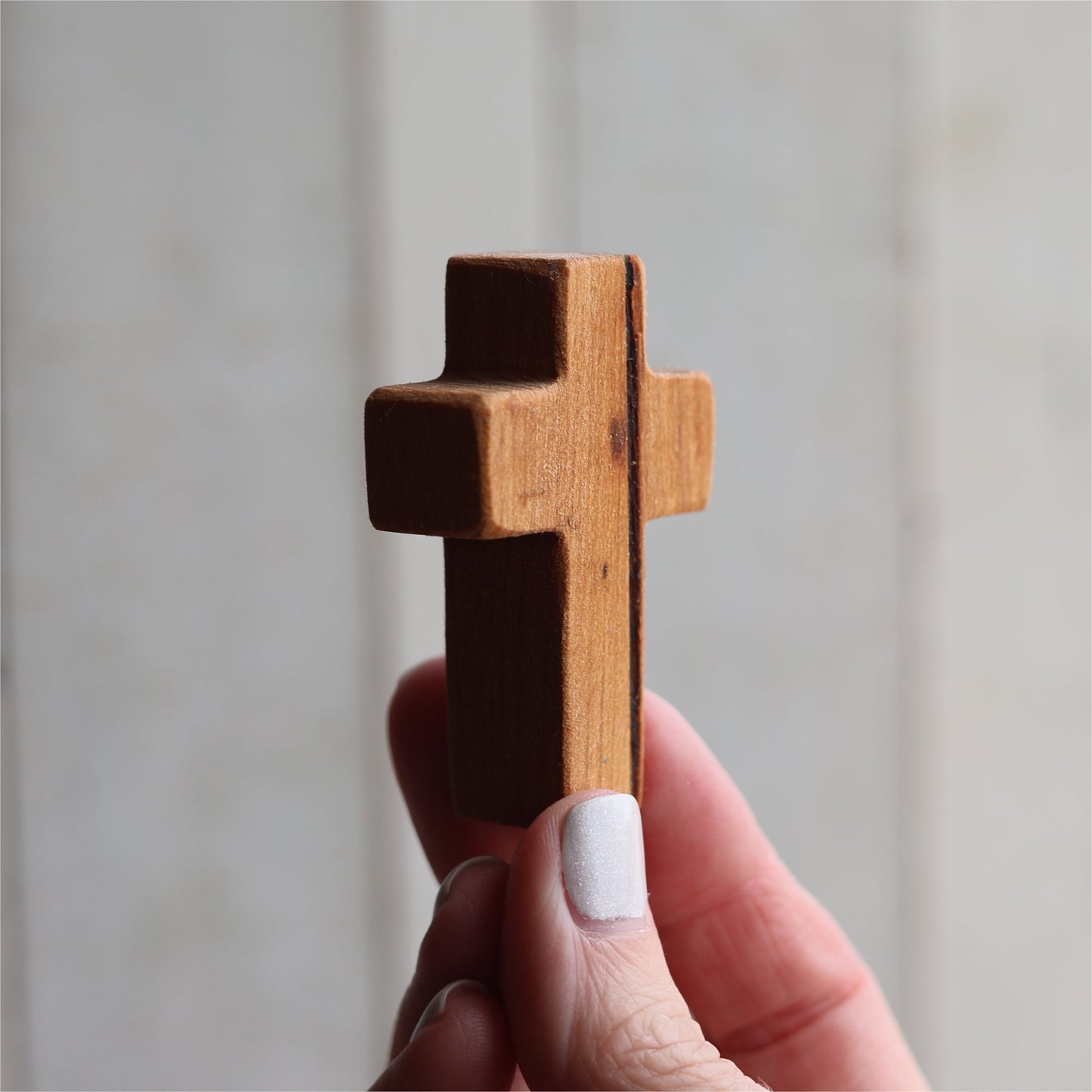 Wooden cross pendant from Dennehey Design Co. featuring a rugged pocket cross design, displayed on a necklace.