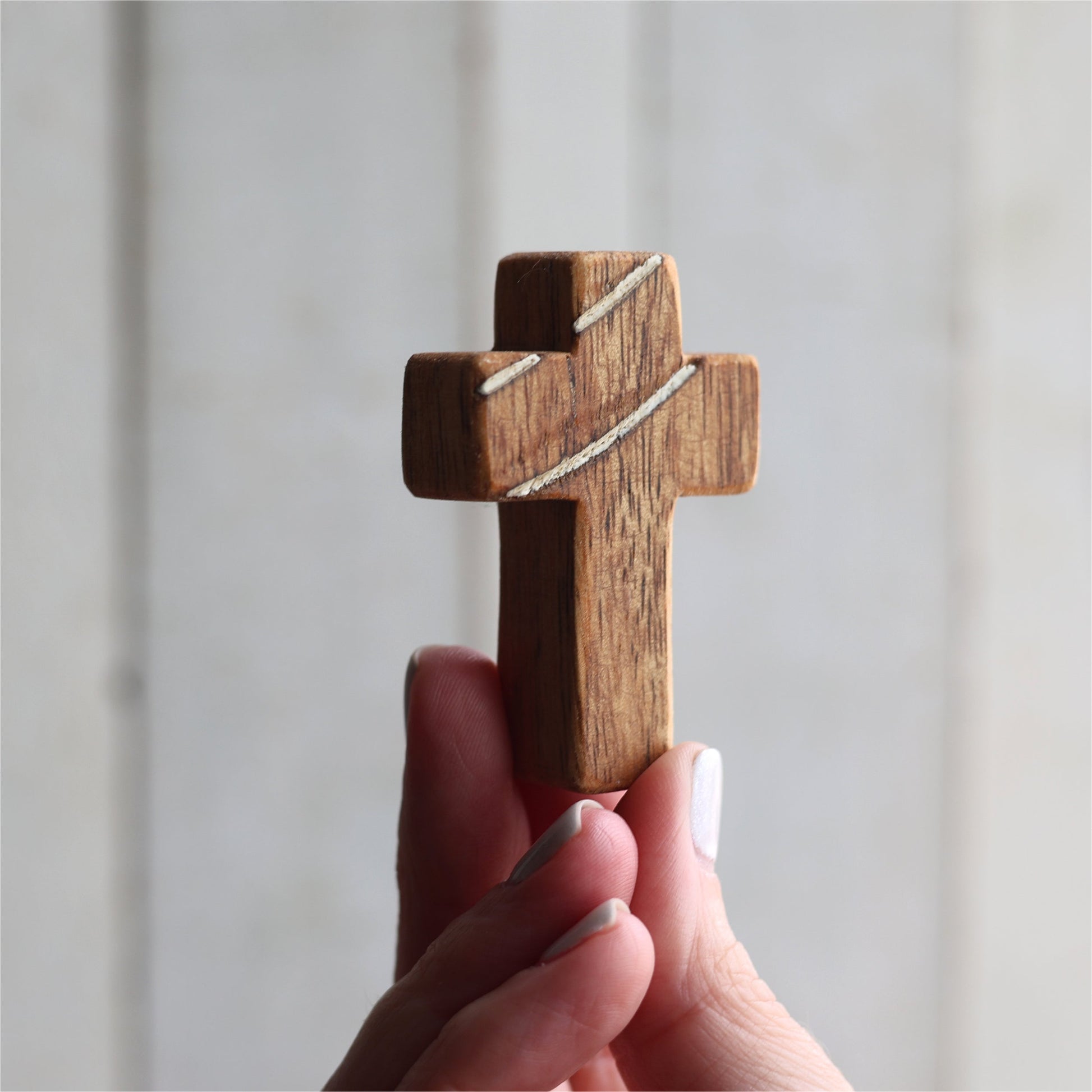 Wooden cross necklace from Dennehey Design Co. featuring a rugged pocket cross design with detailed wood grain.