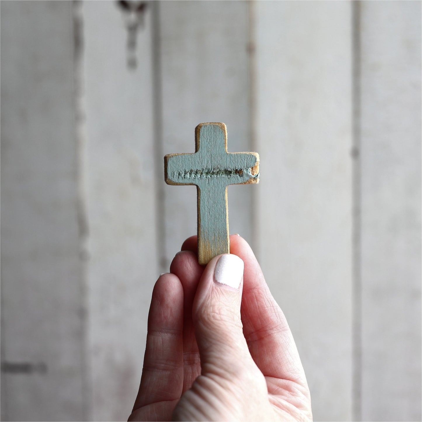 Wooden cross necklace from Dennehey Design Co., featuring a rugged pocket cross design with detailed craftsmanship.