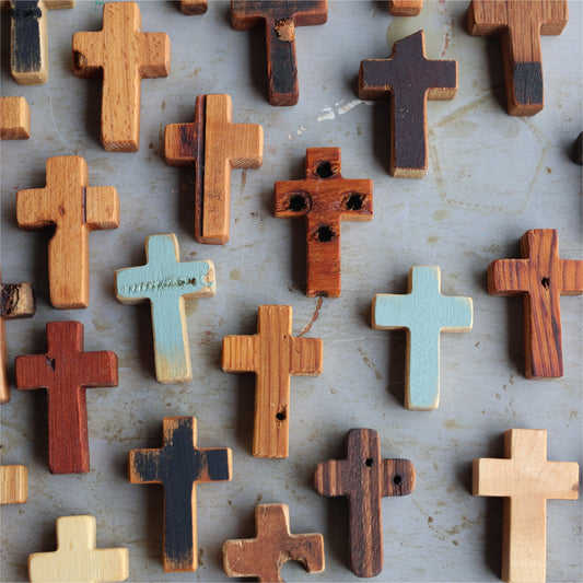 Wooden cross necklace from Dennehey Design Co. featuring a rugged pocket cross with detailed craftsmanship and natural wood finish.