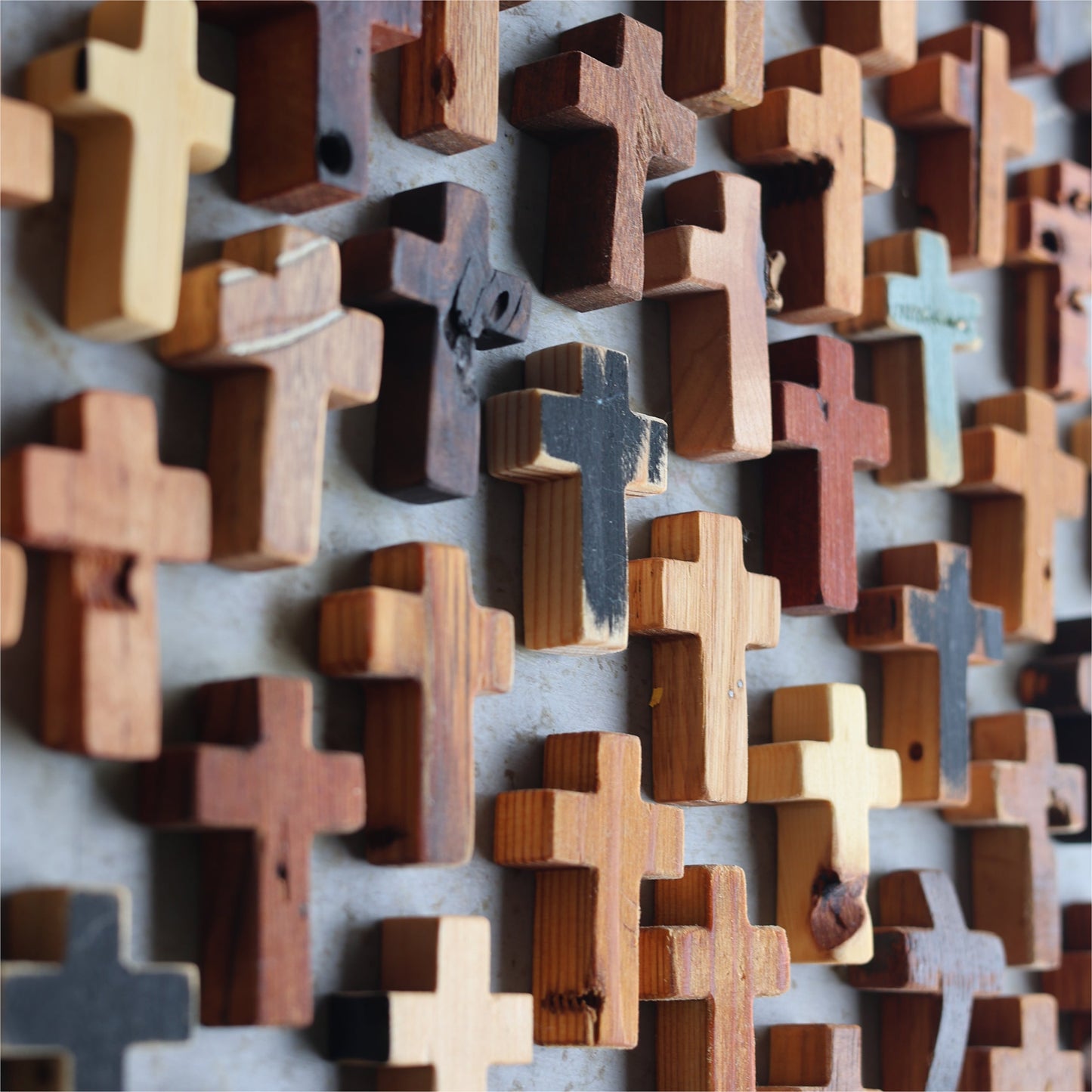 Wooden cross necklace from Dennehey Design Co. featuring a rugged pocket cross design with detailed craftsmanship.