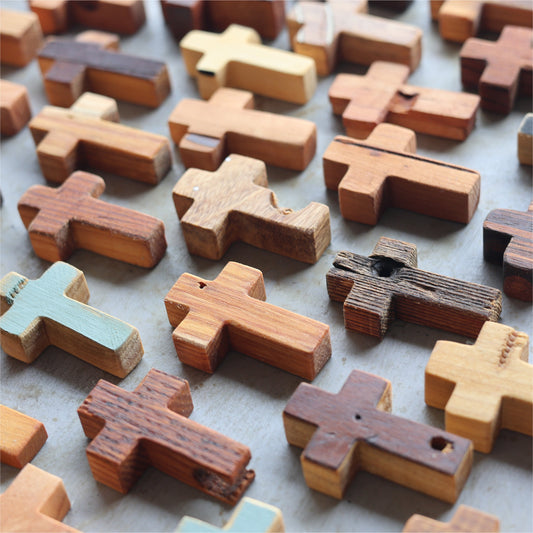Wooden cross necklace from Dennehey Design Co. featuring rugged pocket cross design, displayed on a neutral background.