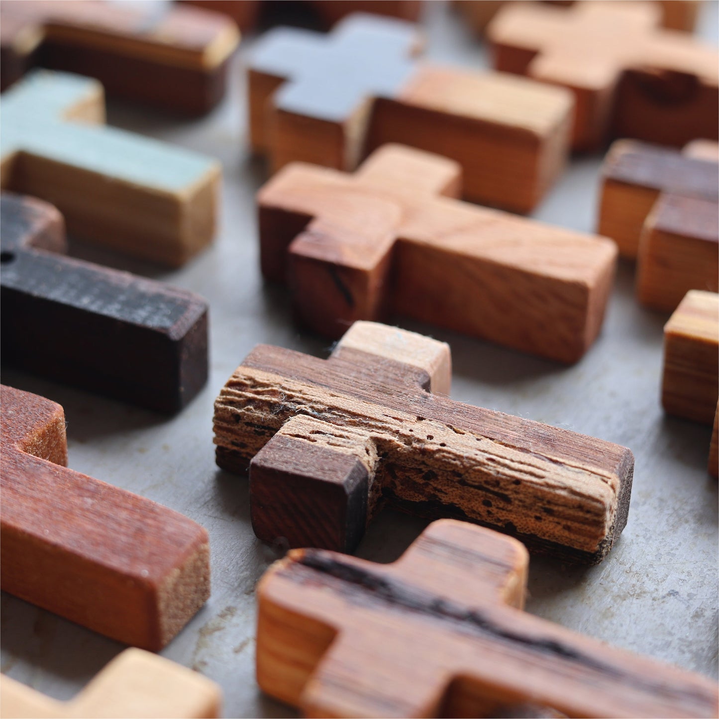 Wooden pocket cross necklace from Dennehey Design Co., featuring a rugged wooden cross pendant on a simple chain.