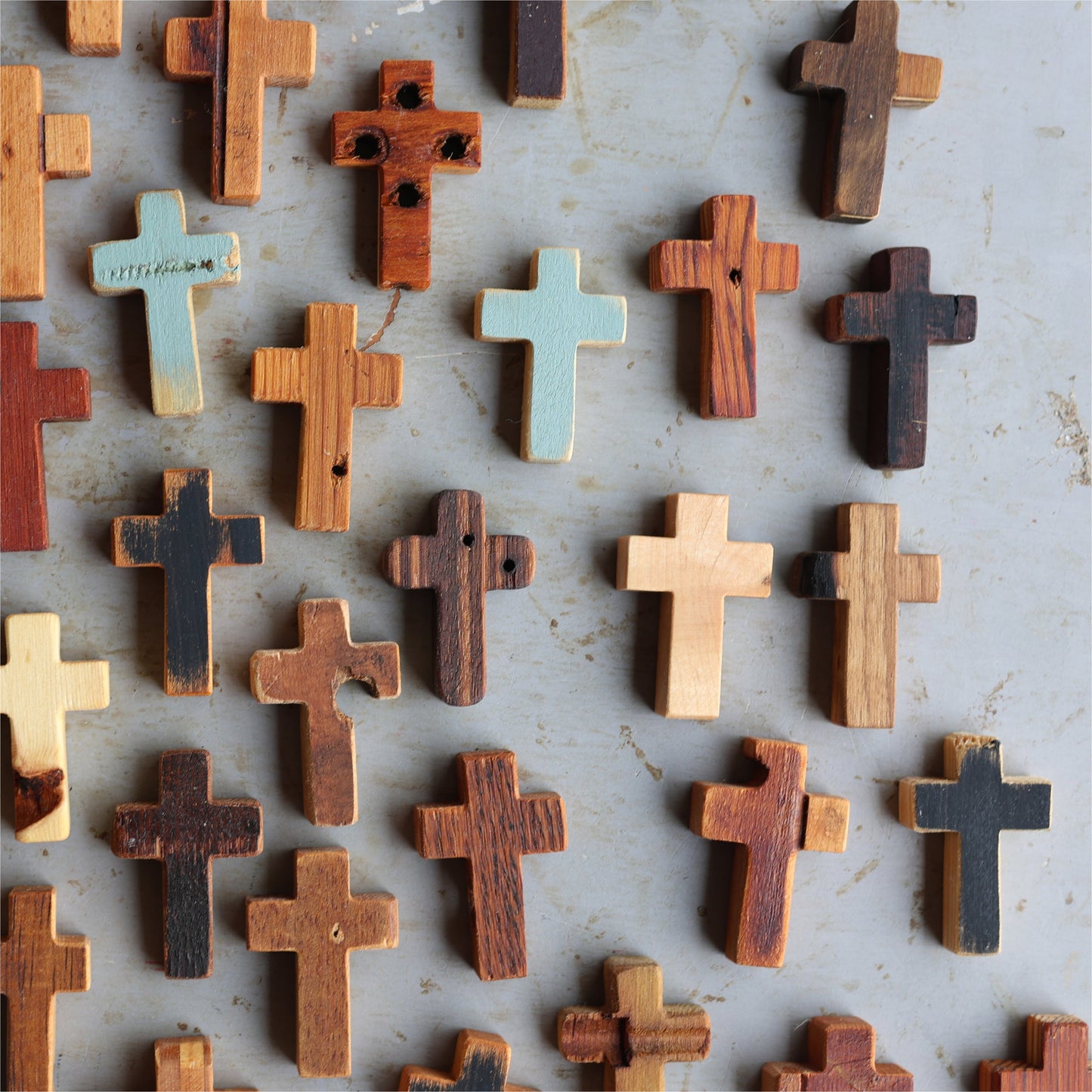 Wooden cross necklace from Dennehey Design Co. featuring rugged pocket cross design, displayed on a neutral background.