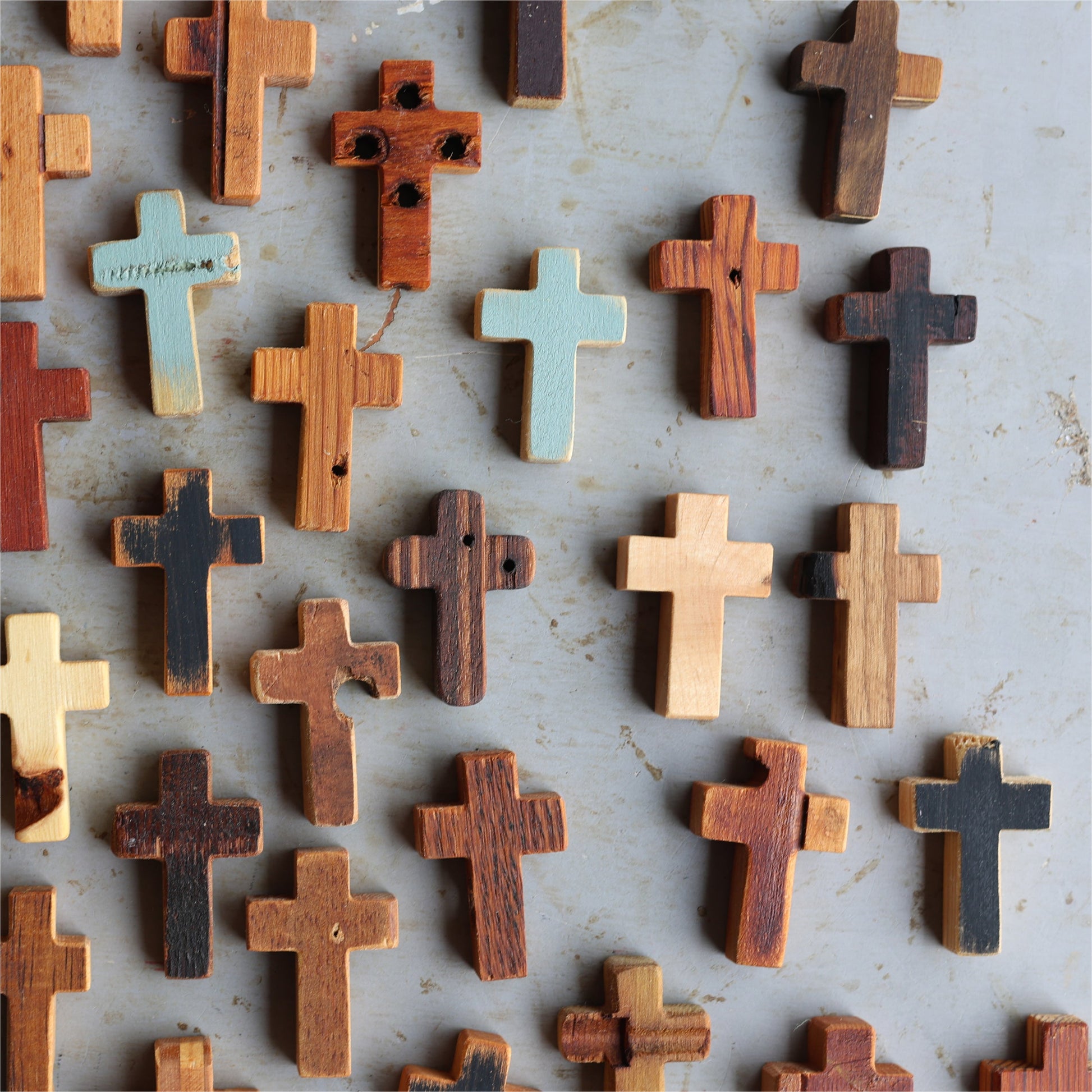 Wooden cross necklace from Dennehey Design Co. featuring rugged pocket cross design, displayed on a neutral background.