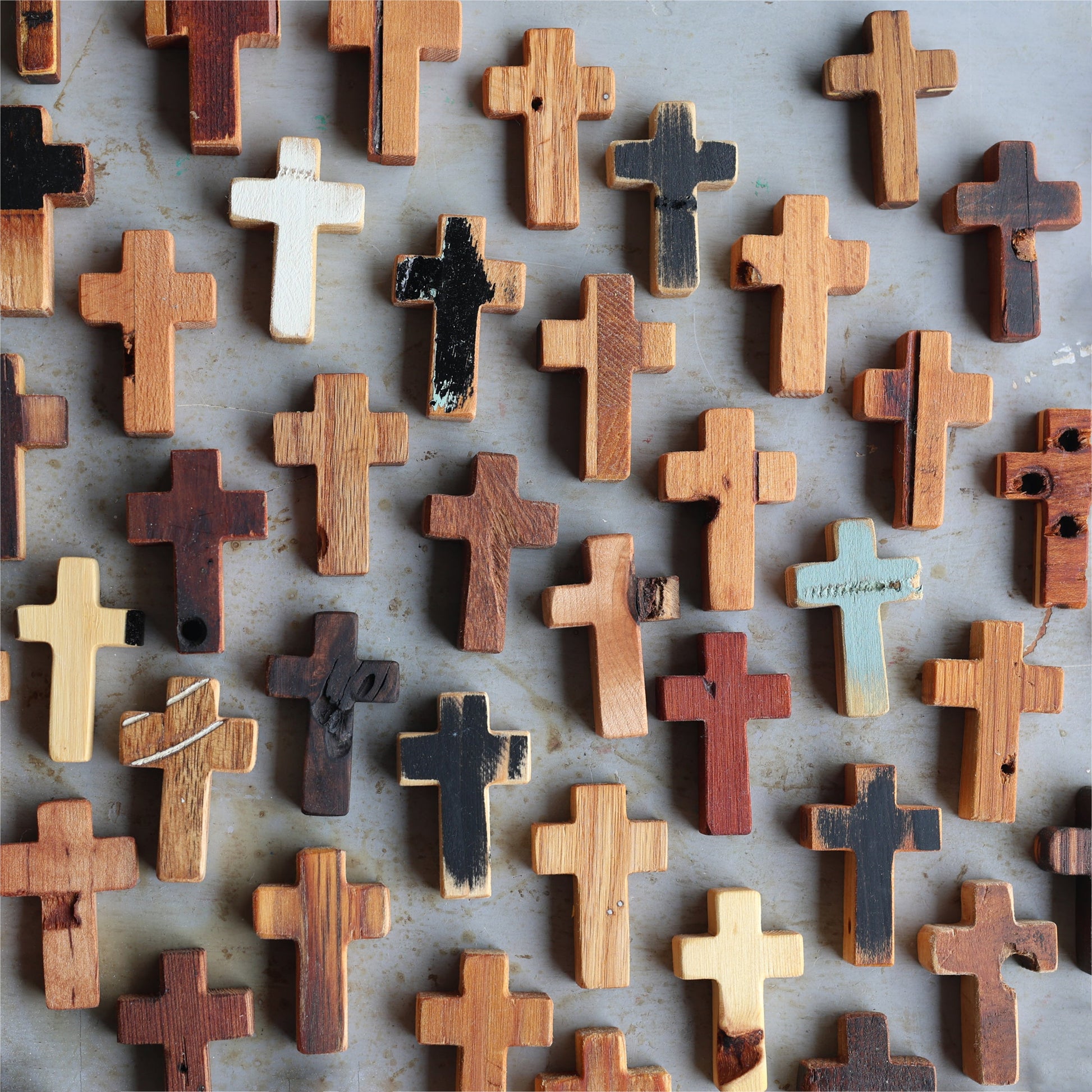 Wooden pocket cross necklace by Dennehey Design Co. featuring a rustic wooden cross pendant on a leather cord.