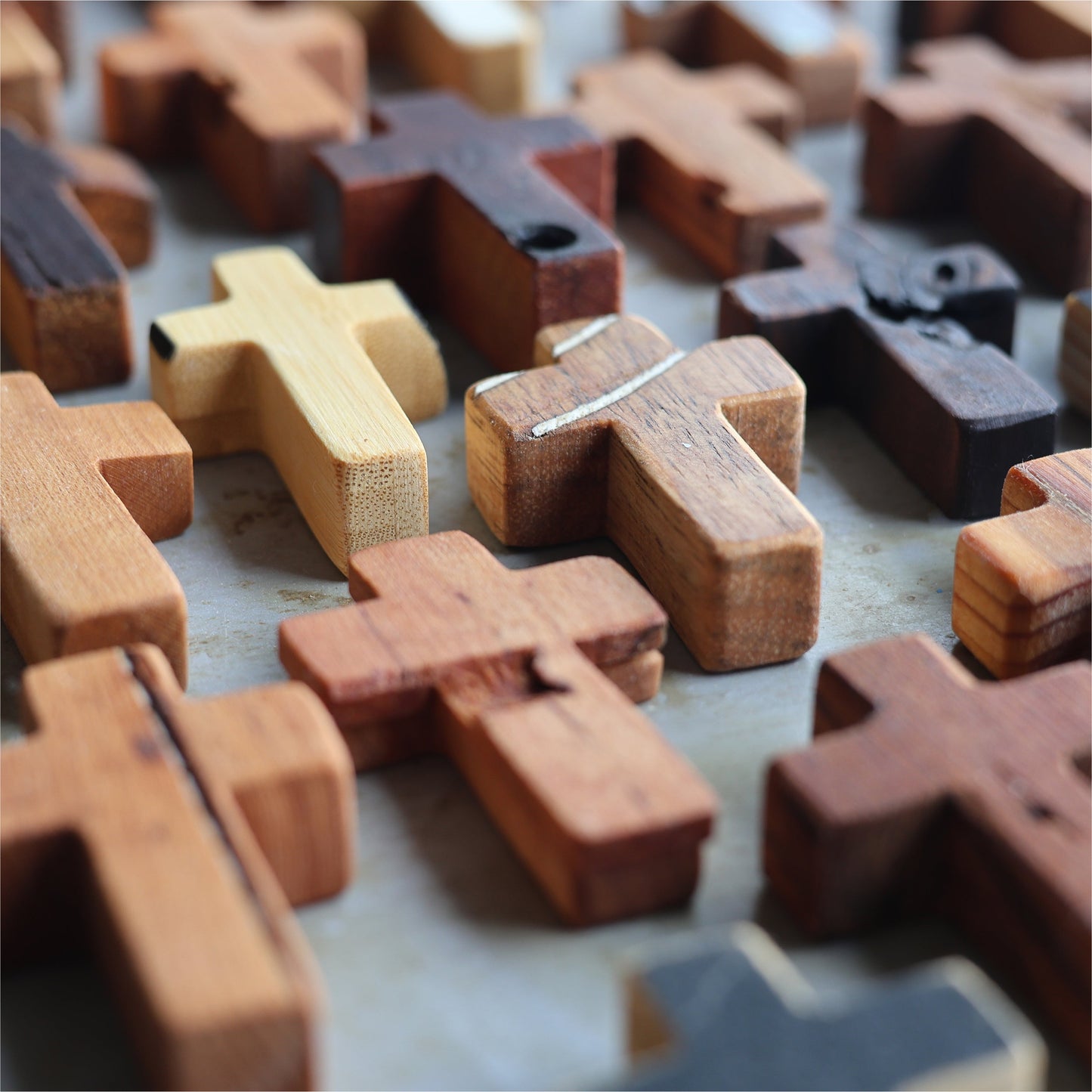 Wooden cross necklace from Dennehey Design Co. featuring a rugged pocket design, displayed on a neutral background.