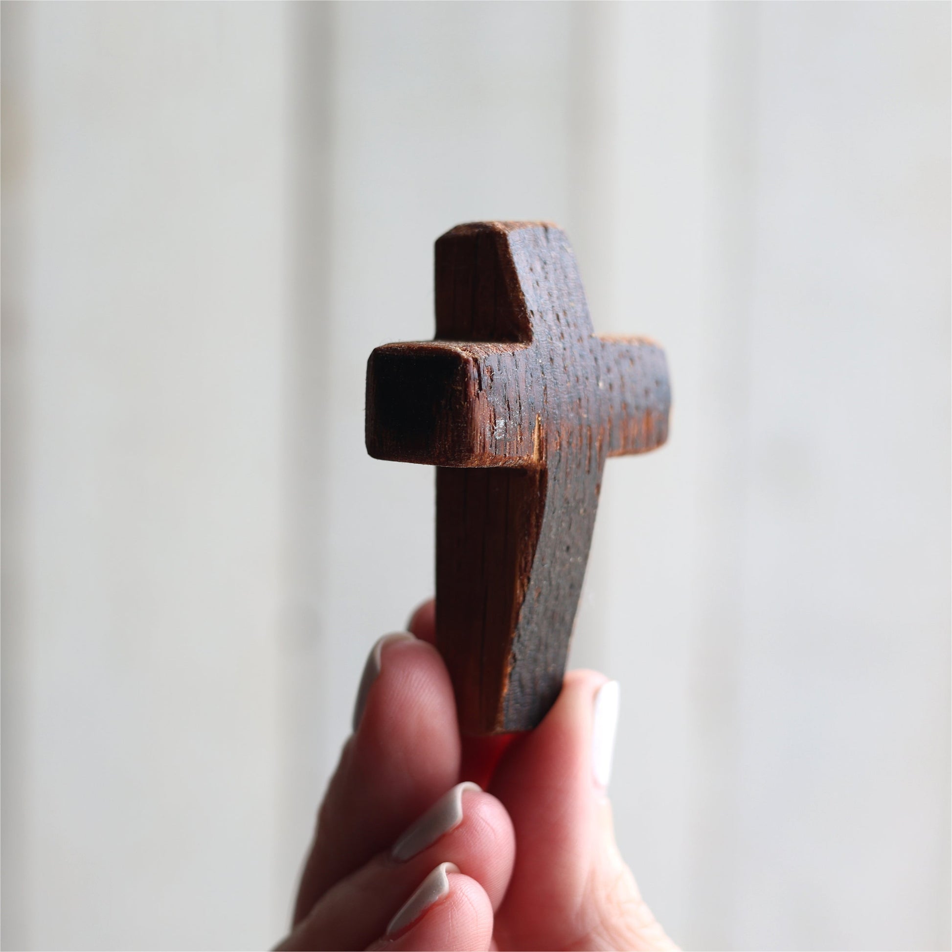 Wooden cross necklace from Dennehey Design Co. featuring a rugged pocket cross design with detailed craftsmanship.