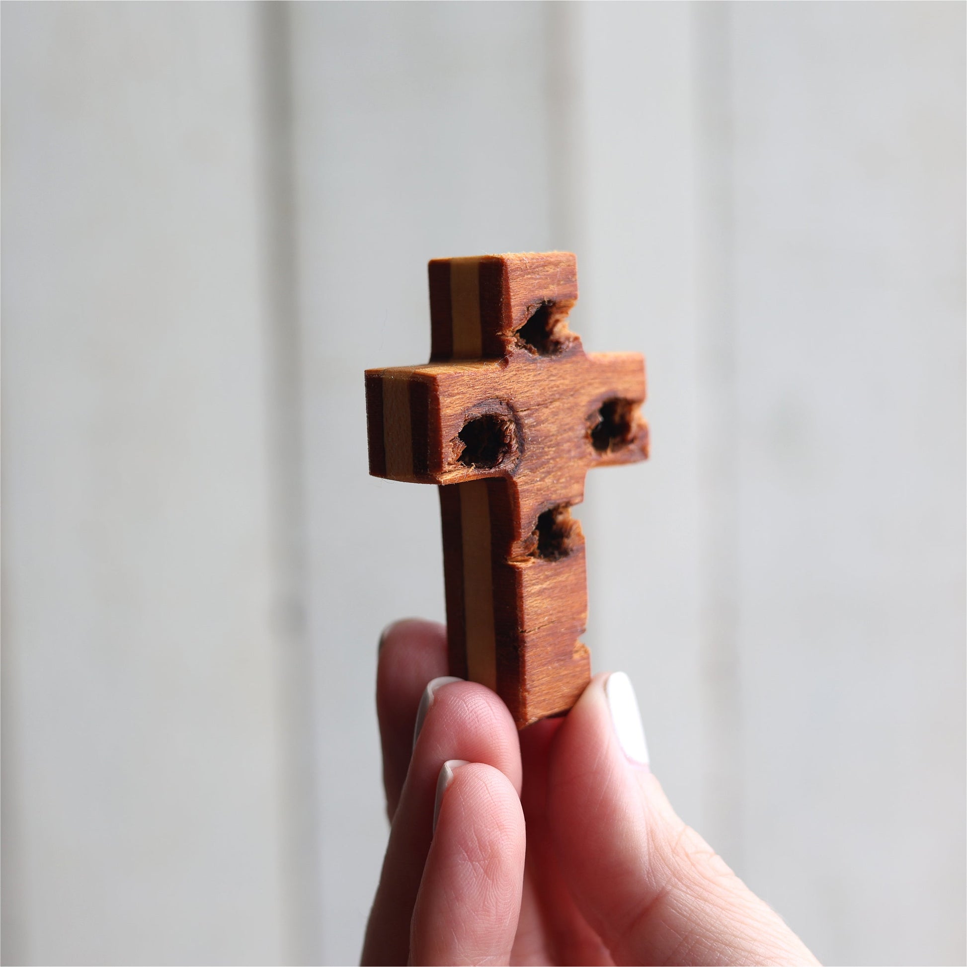 Wooden cross necklace from Dennehey Design Co. with rugged pocket cross design, featuring detailed craftsmanship and natural wood finish.