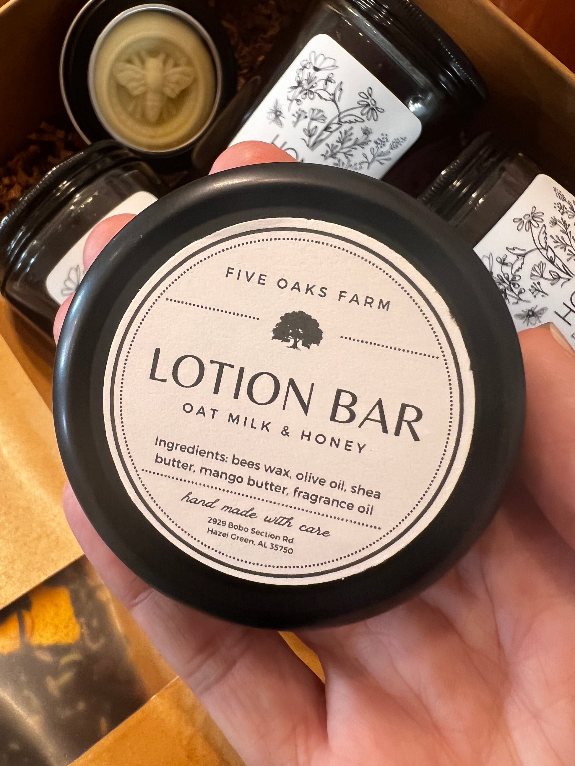 Natural lotion bar from Five Oaks Farm, showing a rustic, handmade skincare product in a reusable tin container.