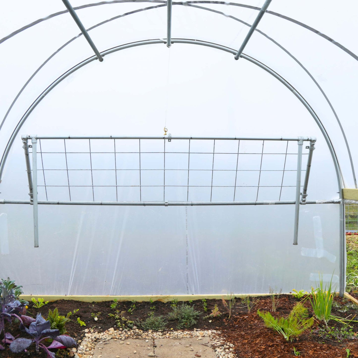 Foldable DIY potting bench by Bootstrap Farmer, showing a wooden work surface with foldable legs and gardening storage features.