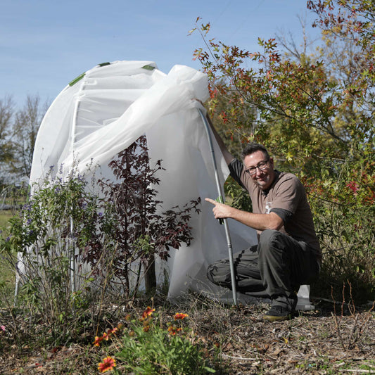 Bootstrap Farmer DIY Tree Protector Kit installed around young trees in a garden setting for protection and growth.