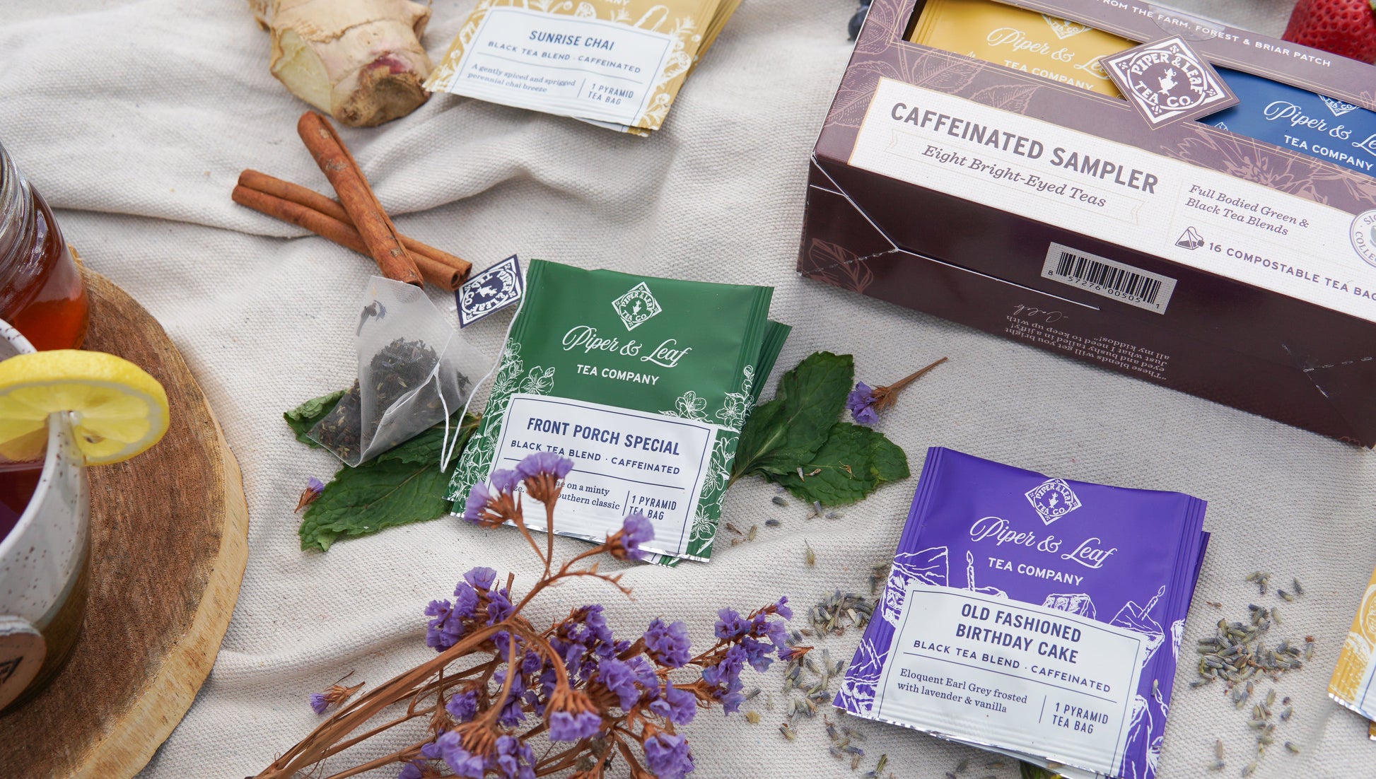 Assorted Piper and Leaf Tea Co. caffeinated tea bags in a tasting flight box of 12, showing individual tea bag packaging and branding.