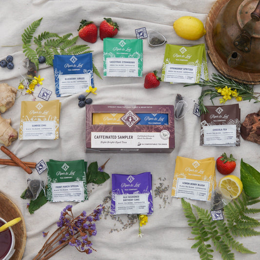 Assorted caffeinated tea bags from Piper and Leaf Tea Co. in a box of 12, showing individual tea bags with labels and packaging.