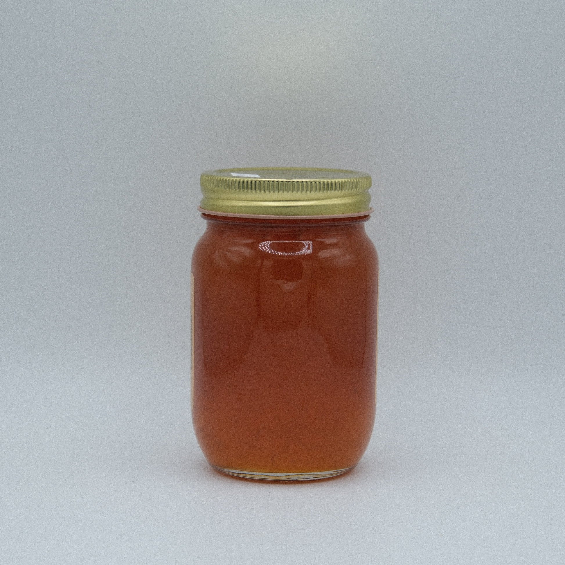 Canned apricot jam in an 18 oz jar from Amish Country Store, showing the golden-orange jam inside a glass jar.