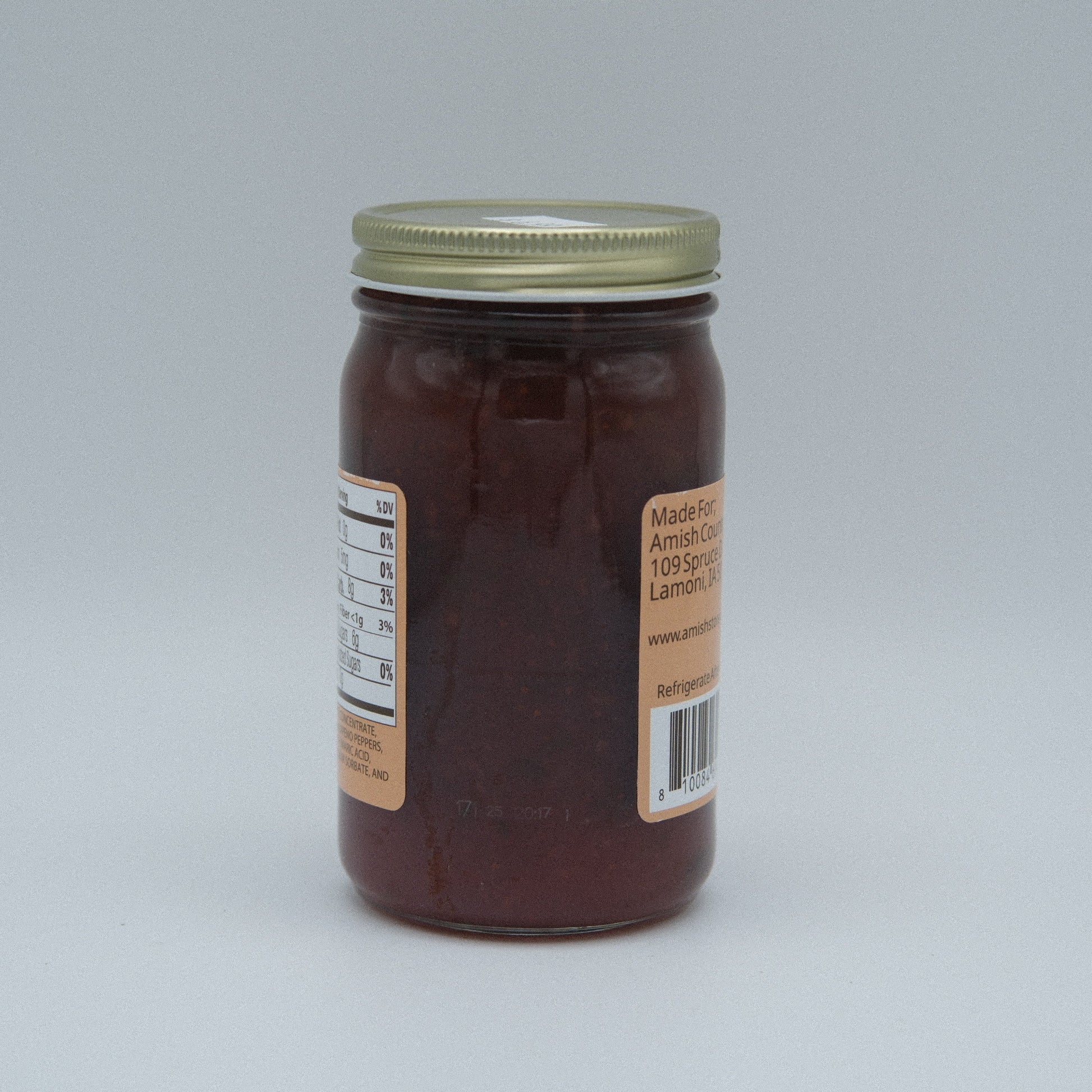 Canned strawberry jalapeno jam by Amish Country Store in a 9 oz jar, showcasing fresh strawberries and jalapenos, no sugar added.