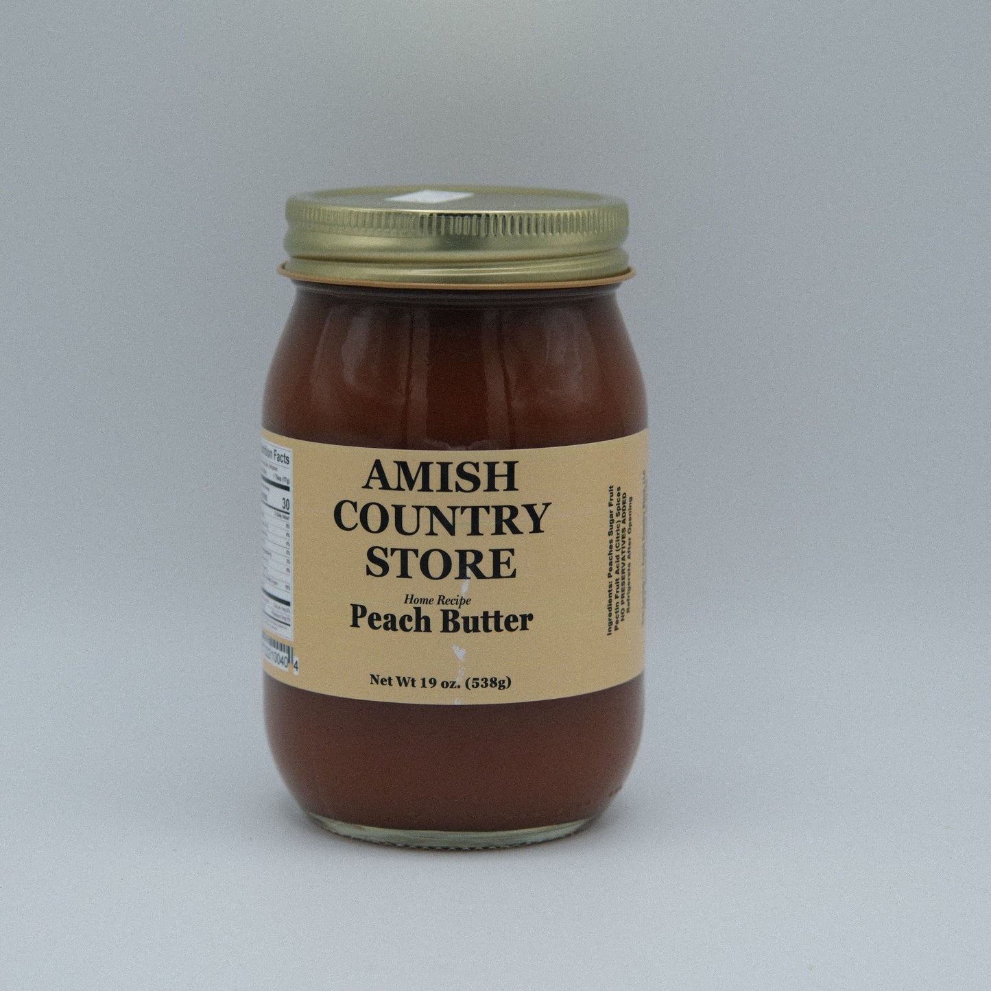 Canned peach butter in a 16oz jar from Amish Country Store, showing smooth, peach-colored spread with a lid.