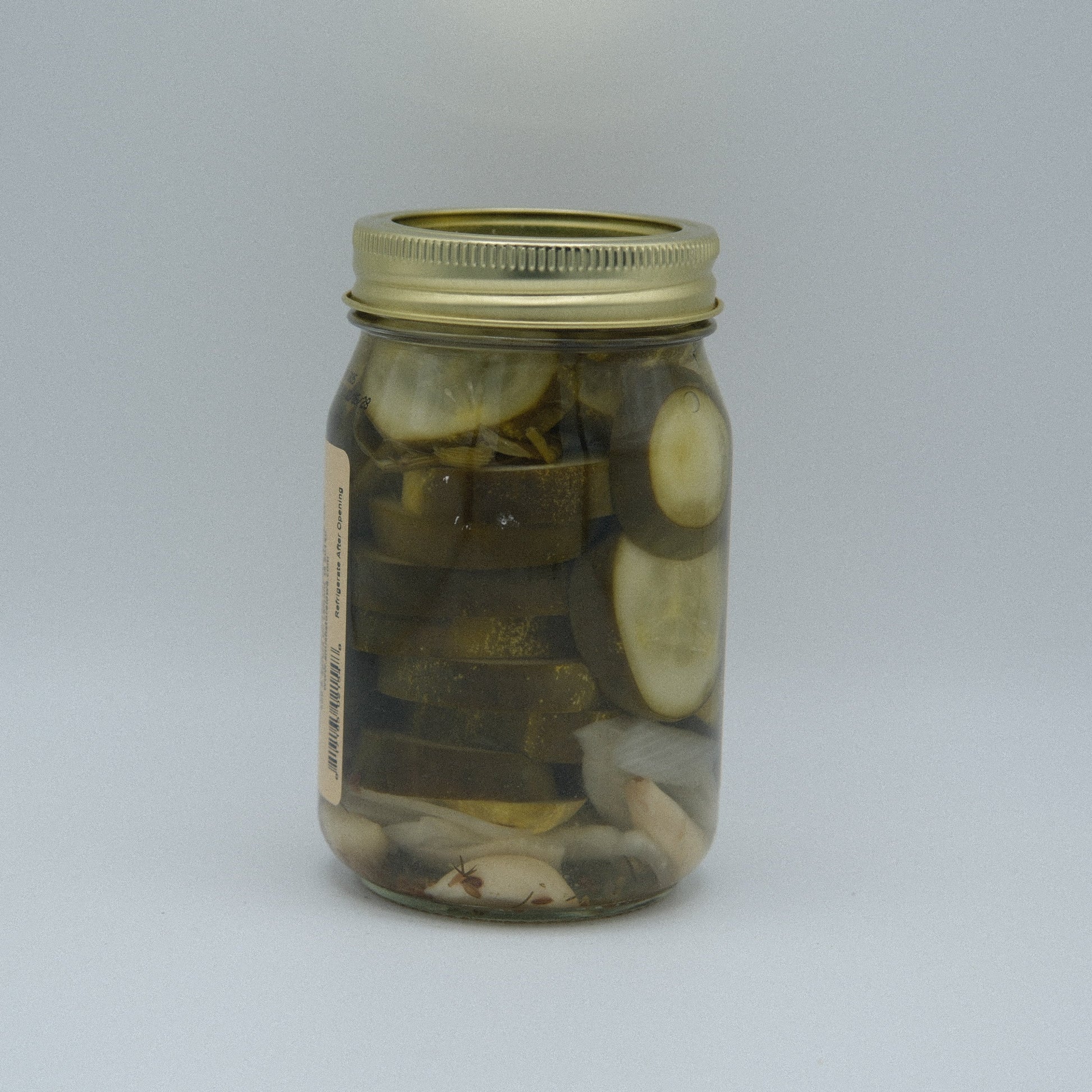 Canned Amish Country Store What'cha Dill Pickles Coin Cut 16 oz jar with bright label and dill pickle slices visible inside.