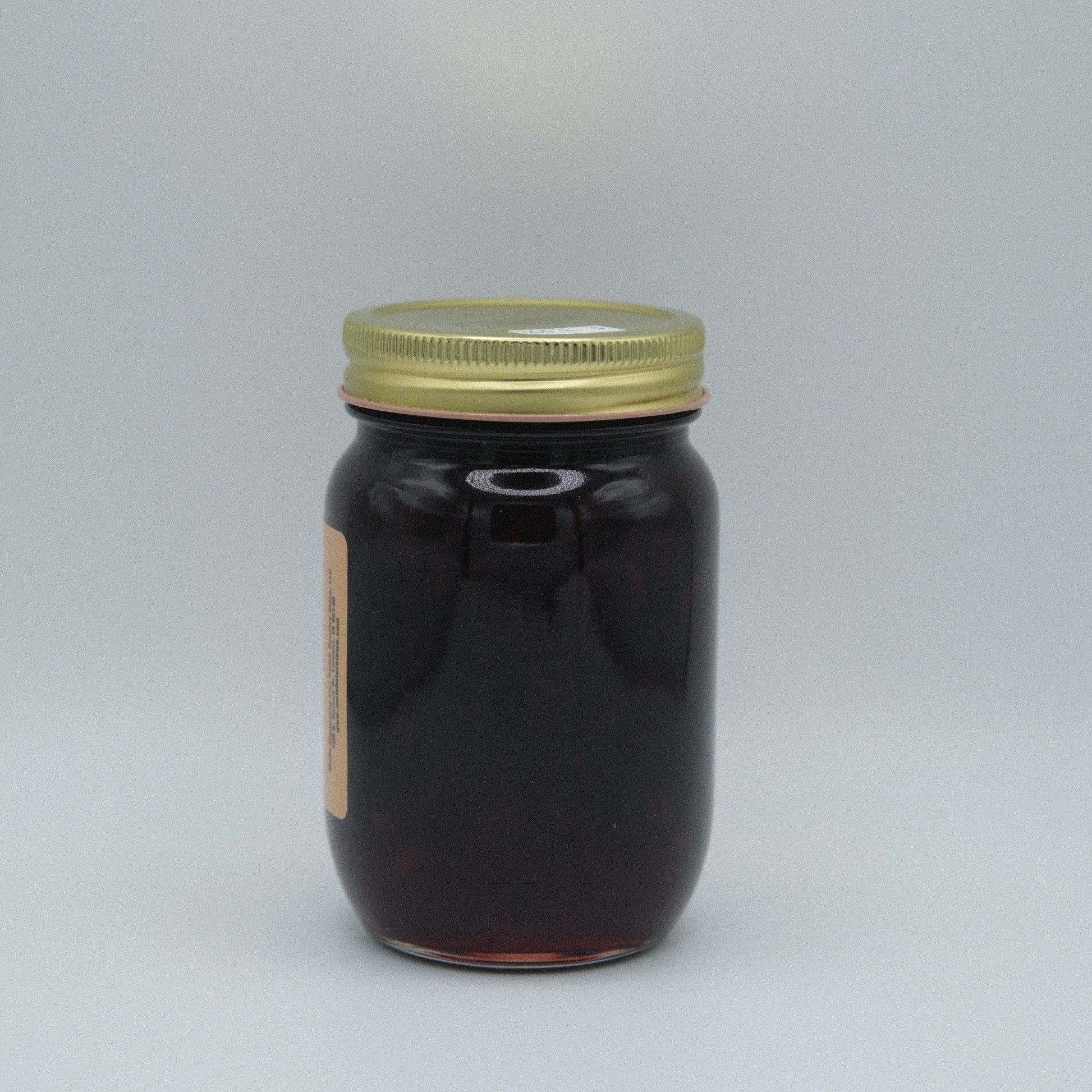 Canned Black Cherry Jam in an 18 oz jar from Amish Country Store, featuring dark cherry preserves with a glossy finish.