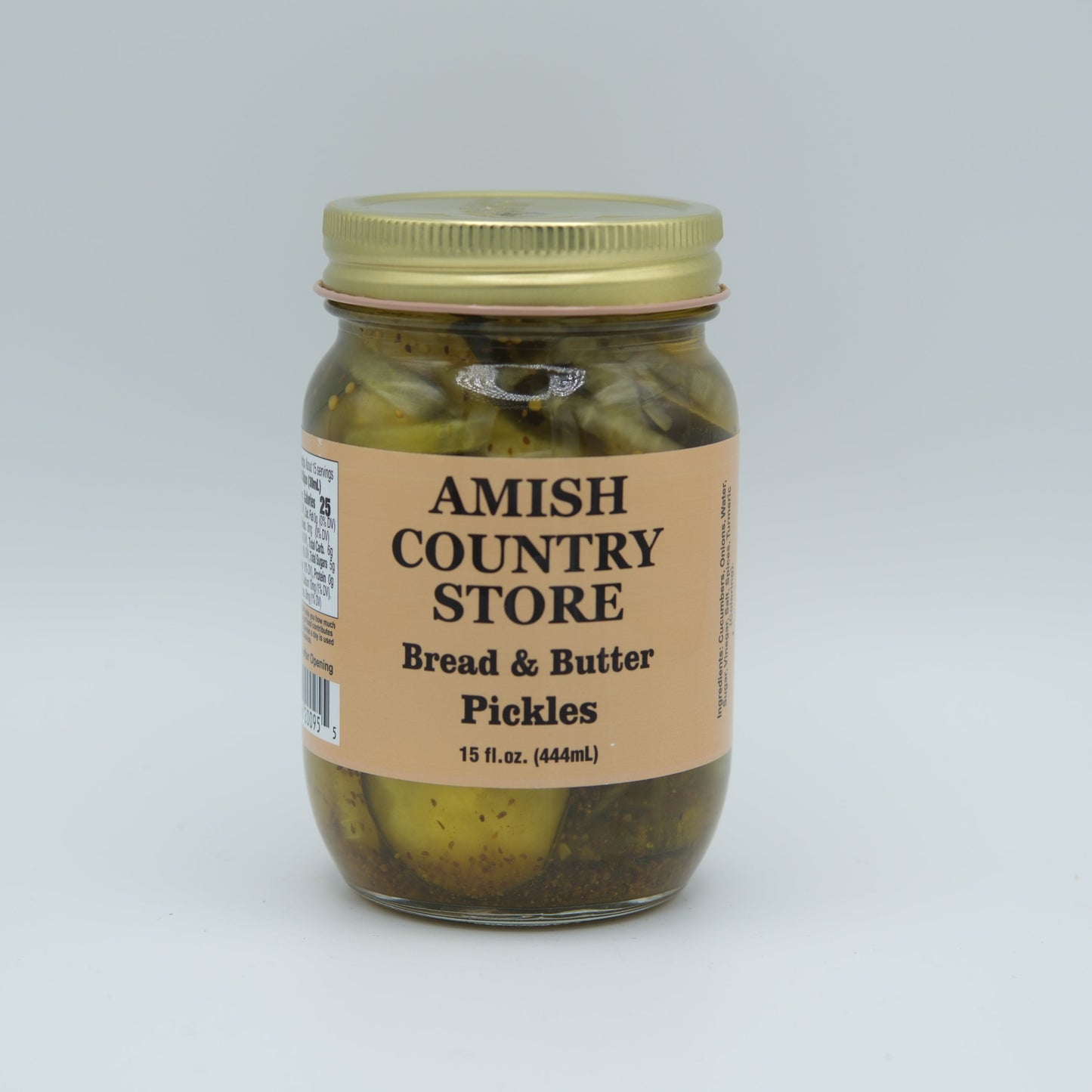 Canned Amish Country Store Bread & Butter Pickles jar, 32 oz, with golden slices and label on a kitchen countertop.