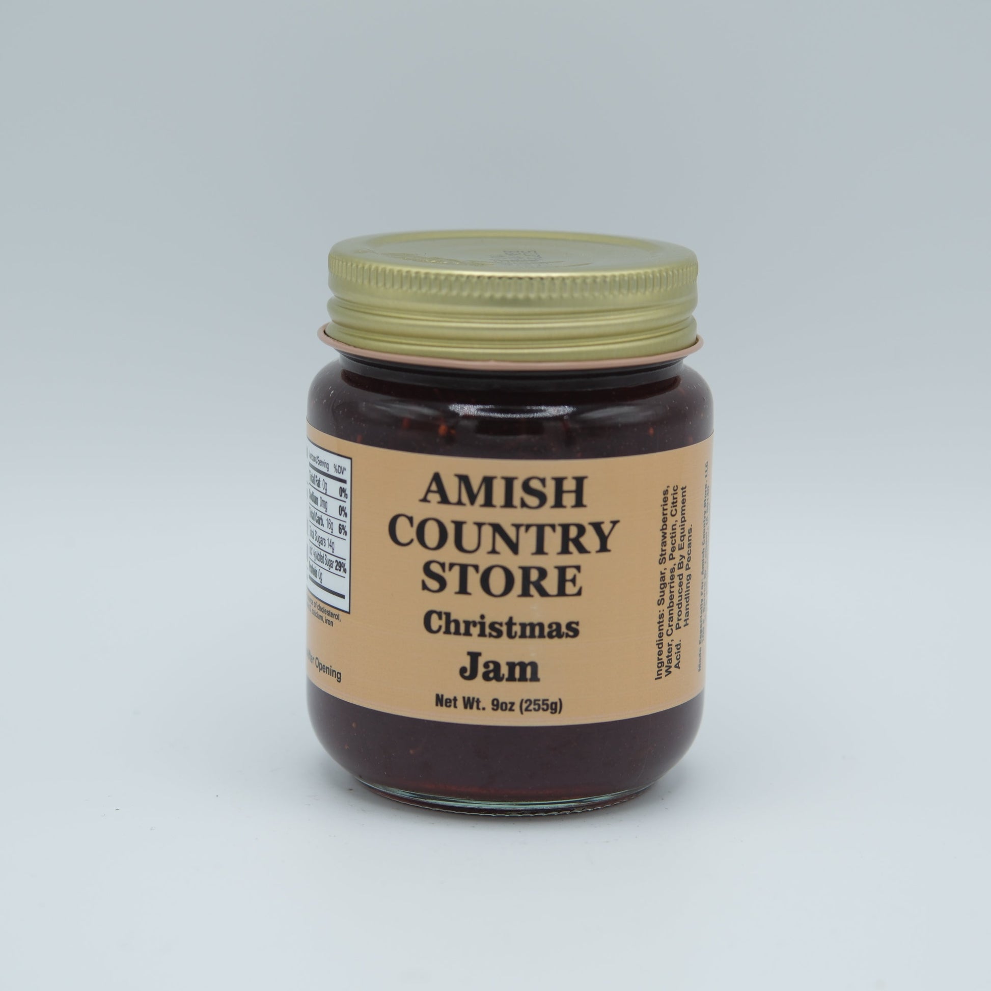 Canned Amish Country Store Christmas Jam in a glass jar with a festive label, showcasing a fruit spread for holiday meals.